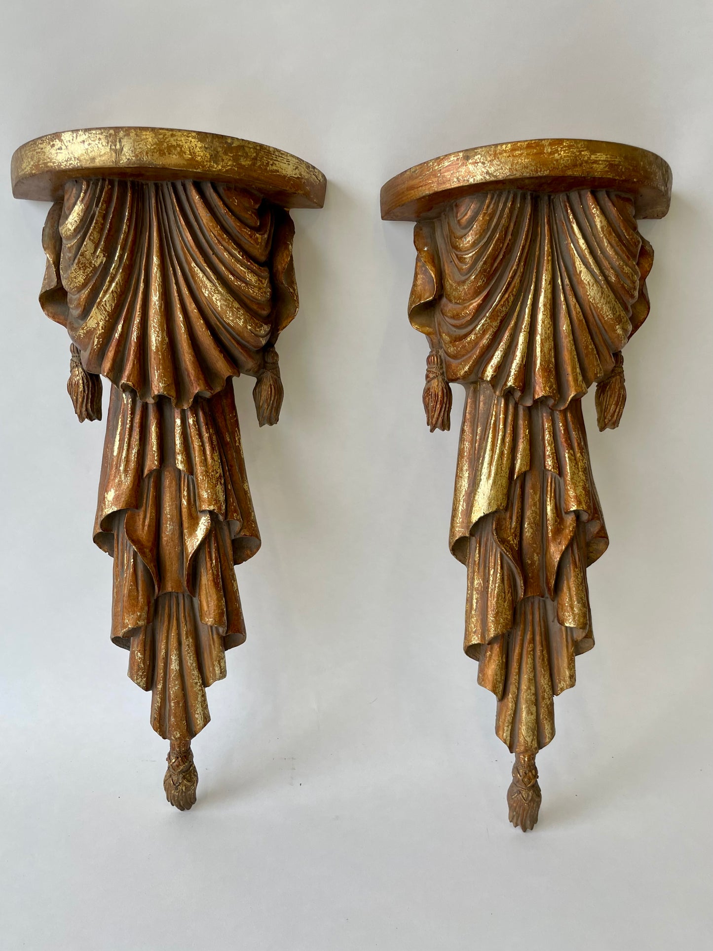 Pair of wood sconce shelves with gold gilding, swags and tassels