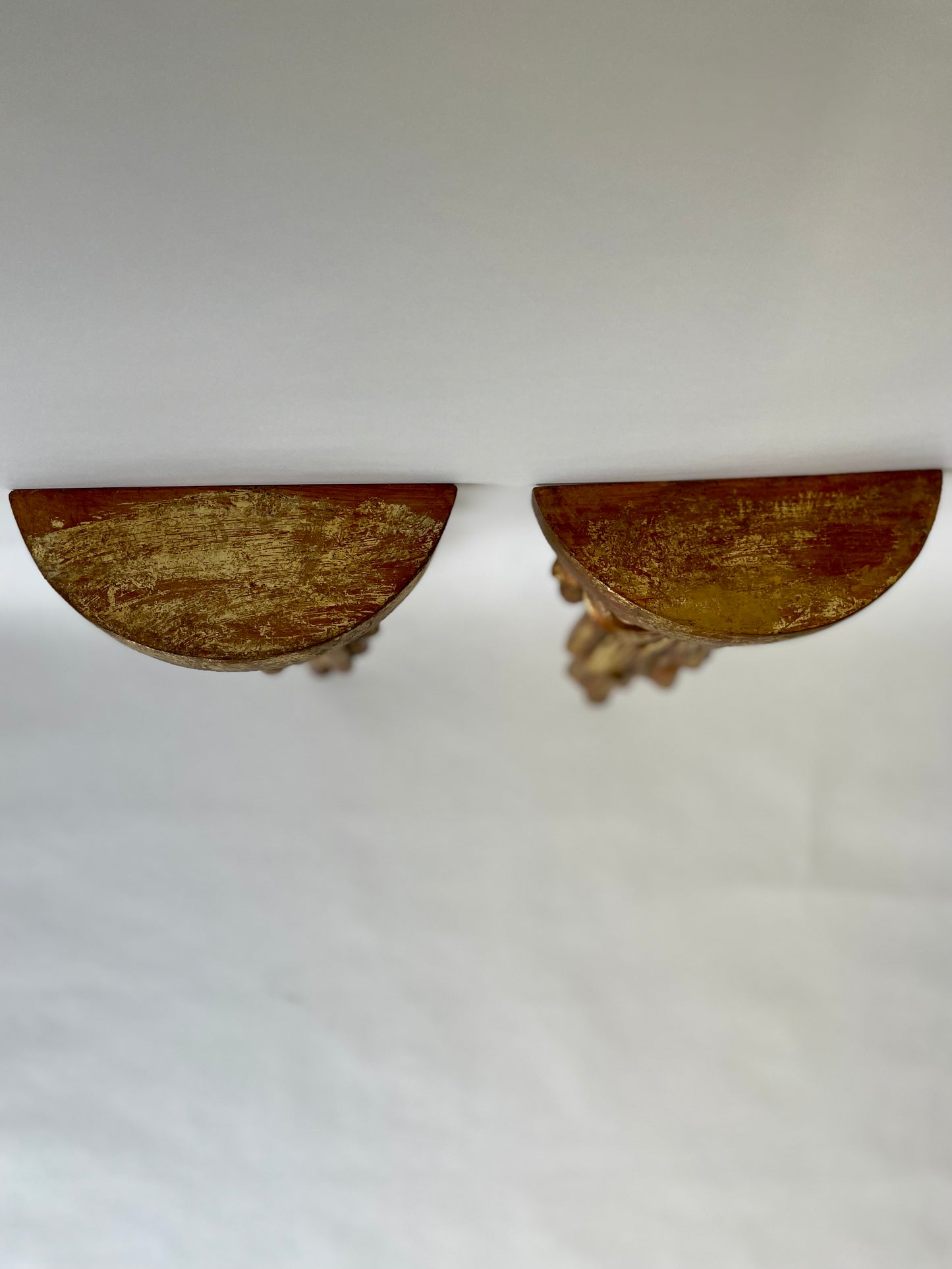 Pair of wood sconce shelves with gold gilding, swags and tassels